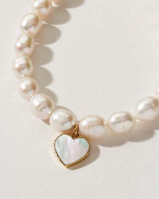 White beaded cultivated pearl necklace with gold and mother of pearl heart charm by Luna Norte Jewelry.
