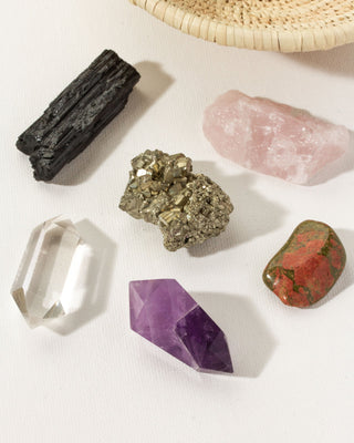 Colorful set of various crystals such as amethyst, pyrite, rose quartz, and quartz by Luan Norte.