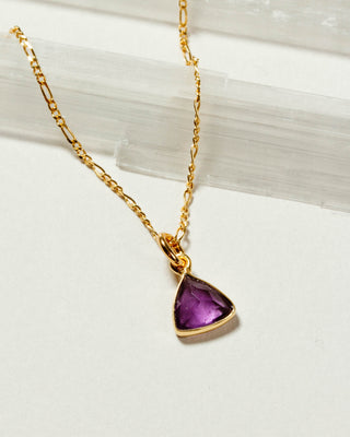 Close up of Amethyst Bermuda Triangle Dainty Collar Necklace with a 14 Karat Gold Plated Brass chain laying on a white background.