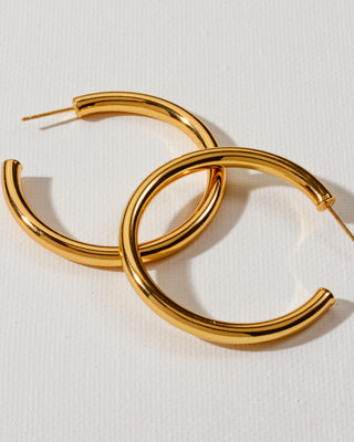 Pair of minimal gold hoop earrings by Luna Norte Jewelry.