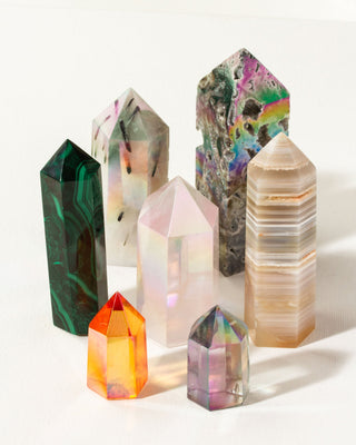 A collection of vibrant and colorful genuine gemstone single point tower crystals by Luna Norte.