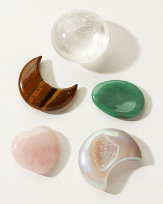 Several smooth heart, moon, and assorted genuine traveling stones by Luna Norte.
