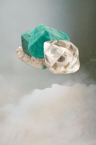 Herkimer diamond and rough Amazonite stone on a cloudy background
