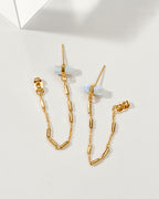 Pair of gold earrings with a front-to-back design with chain accents and moonstones.