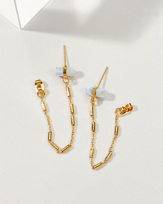 A pair of gold-tone earrings featuring a front-to-back design with chain accents and genuine moonstones.