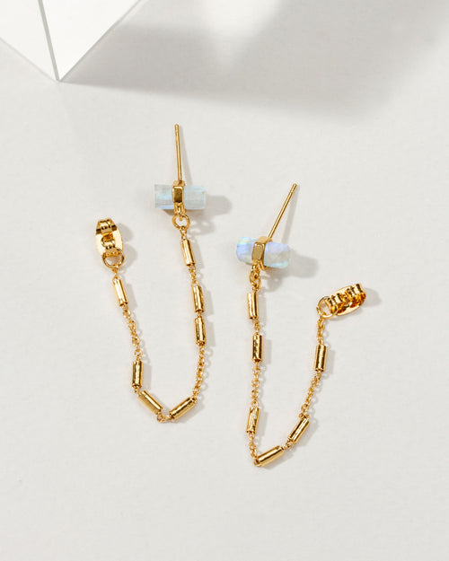 Pair of gold earrings with a front-to-back design with chain accents and moonstones.
