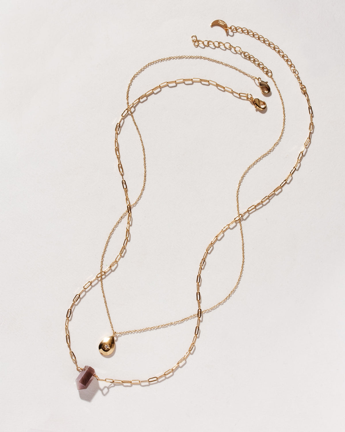 Gold chain necklaces, one with a coffee moonstone pendant, and one with a gold teardrop charm