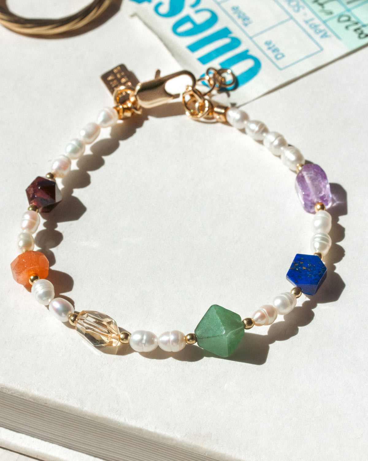 Bracelet with colorful beads on a book