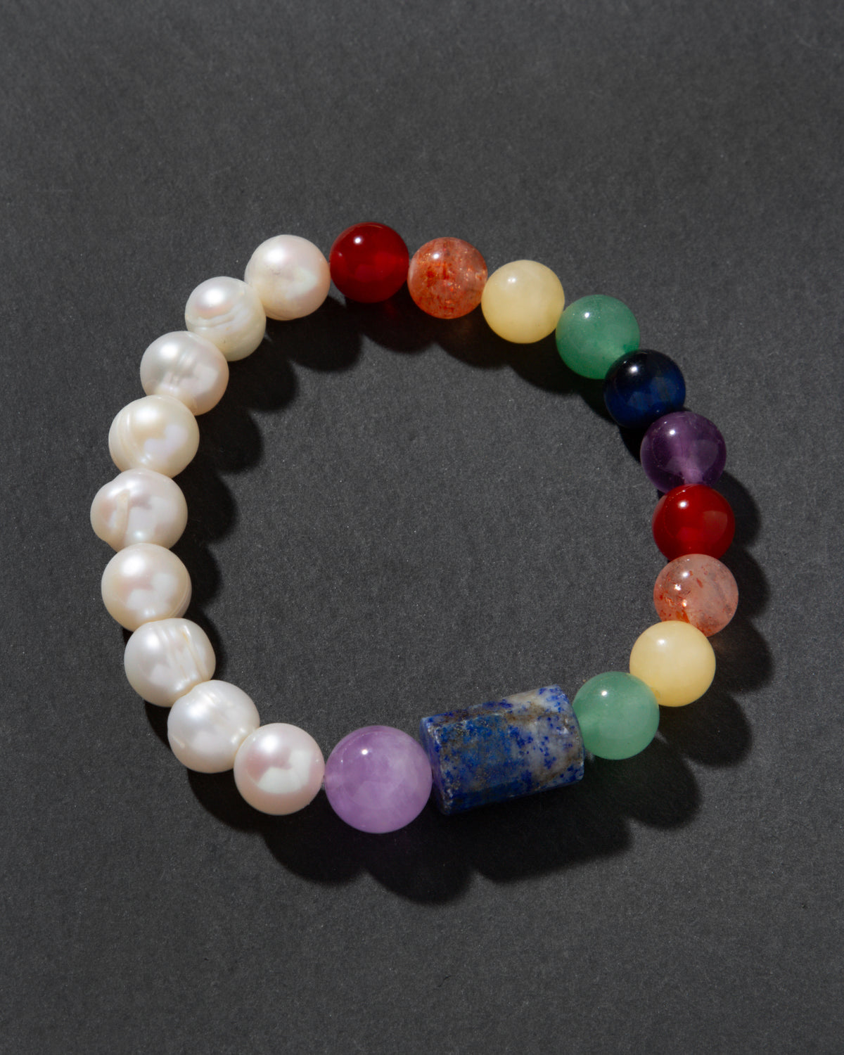 Multicolored beaded bracelet on a dark gray background