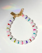 Multicolored beaded bracelet with a gold clasp on a white background