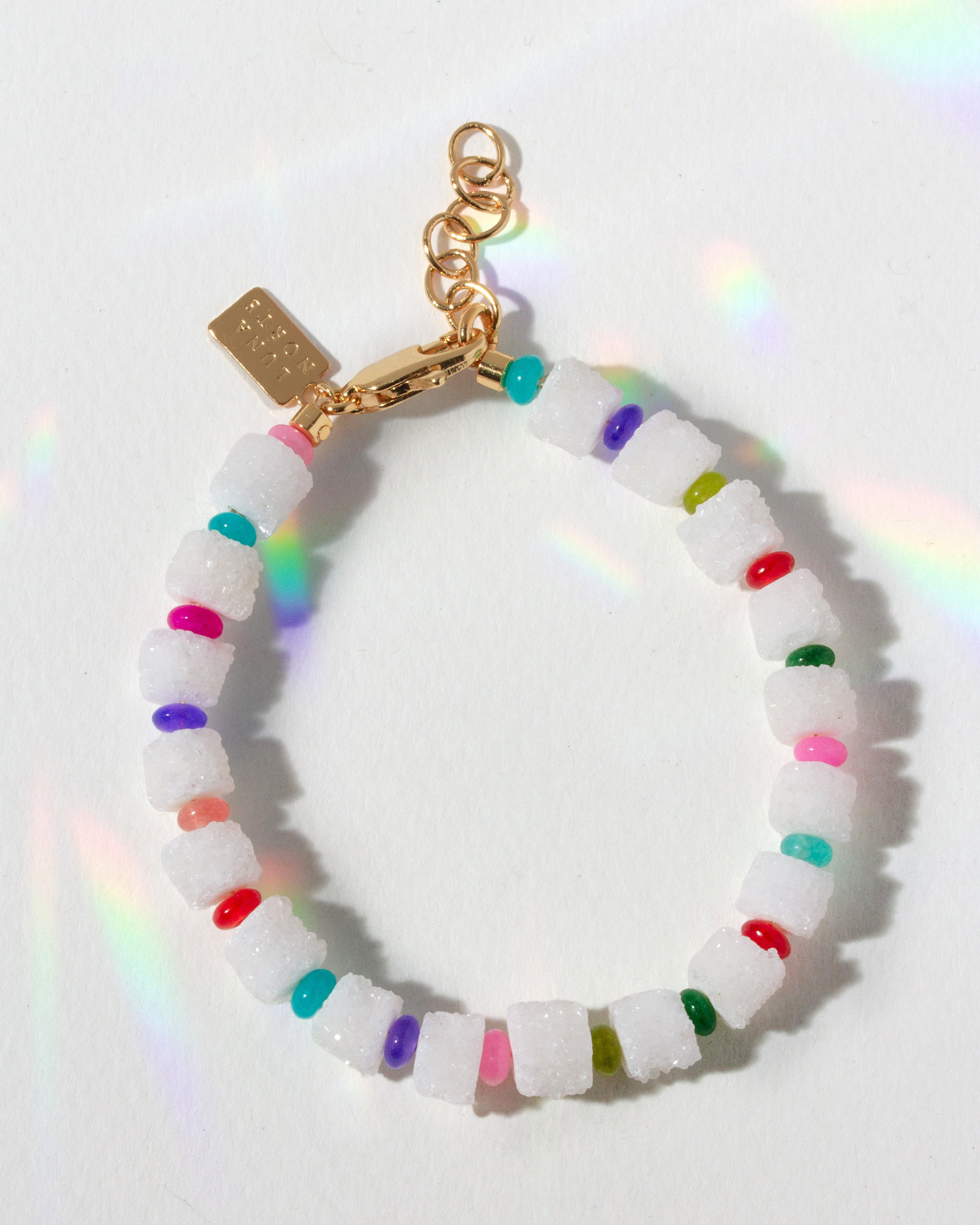 Bracelet with white beads and colorful accents on a white background