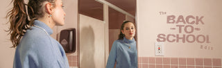 A woman in gemstone jewelry looks in a mirror in a pink bath. Text: 'The BACK TO SCHOOL Edit'