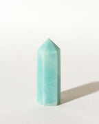Blue-green striped amazonite mini obelisk tower on a white background.