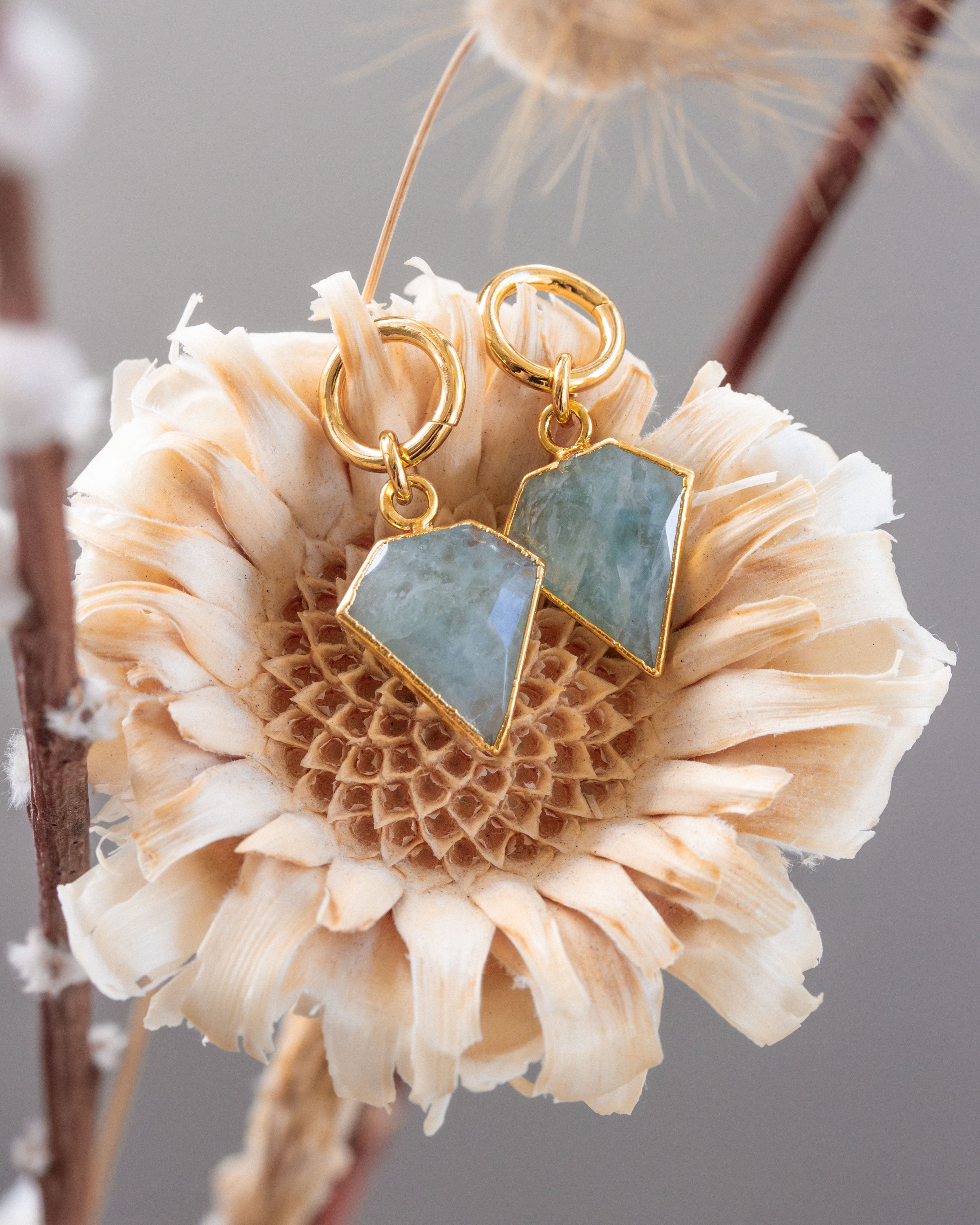 Pair of gold interchangeable earring charms with faceted aquamarine gemstone, shaped like a diamond