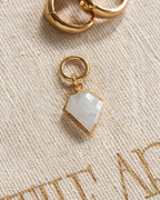 Pair of gold interchangeable hoop earring charms with a faceted moonstone, resembling a diamond