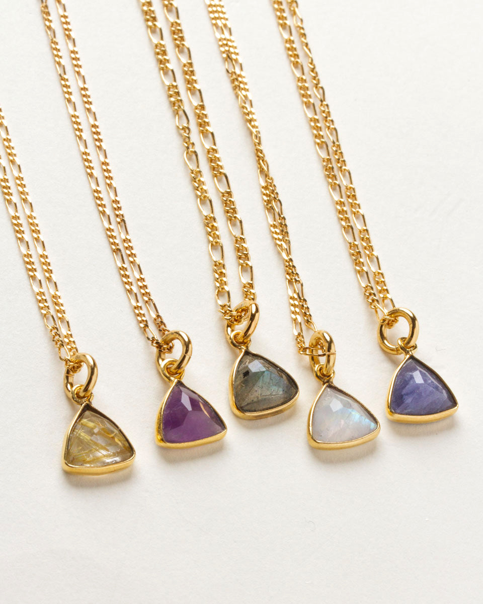 Collection of triangular gemstone pendant necklaces in many colors, with a gold chains and clasps