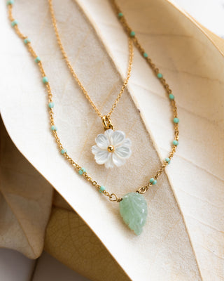 Layered necklace set with green aventurine leaf charm and mother of pearl flower.