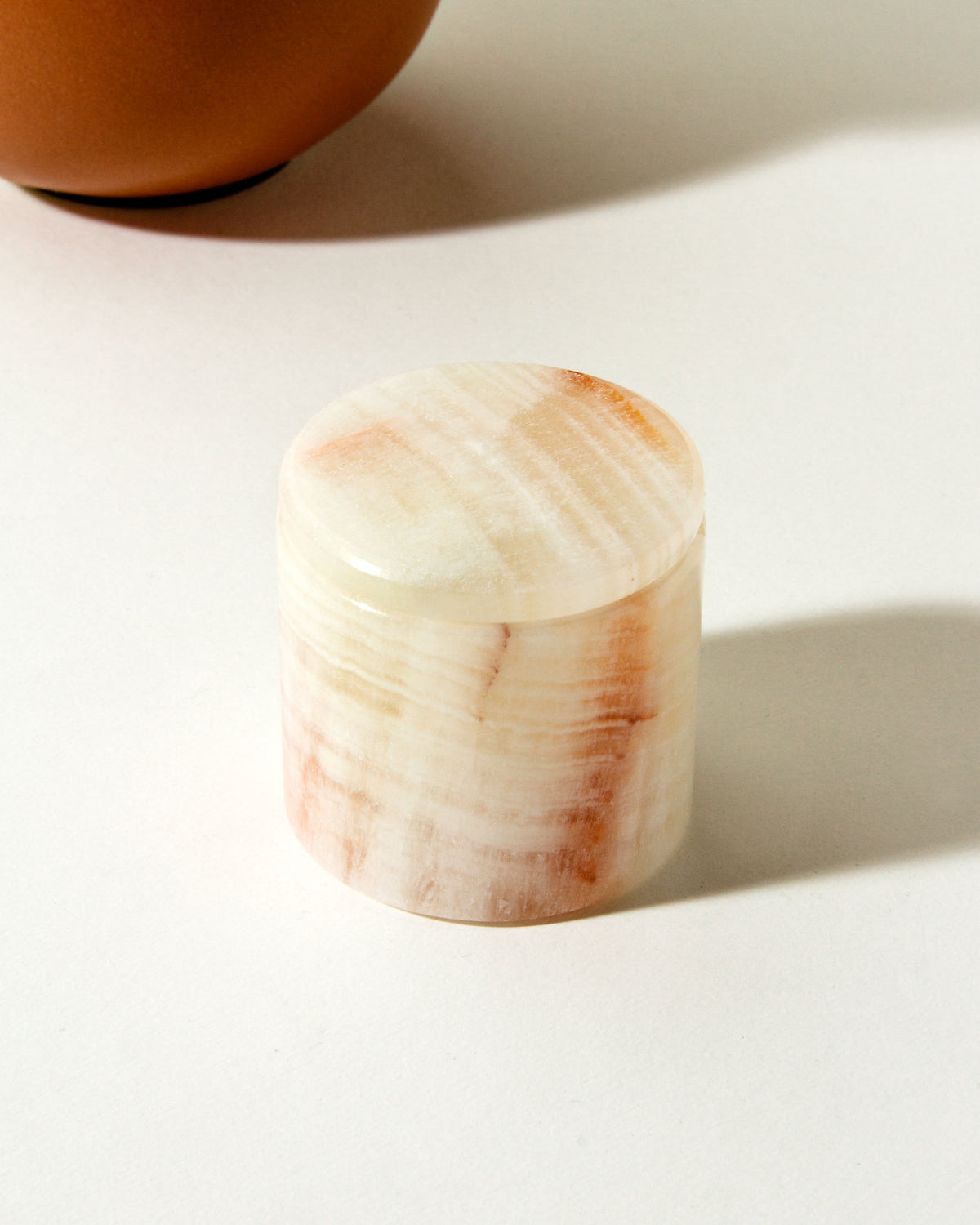 White calcite jewelry box with varied light pink tones.