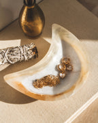 A moon-shaped catch-all dish, carved from calcite