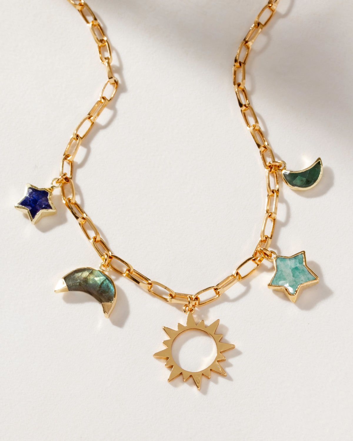 Gold-plated paperclip charm necklace with multicolor moon, star, and sun charms