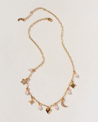 Gold necklace with many rose quartz, gold plated, and cz charms with heart, moon, and star shapes.