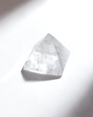 clear crystal quartz pyramid on a white background