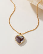 Coffee moonstone heart-shaped gold necklace on a white background.