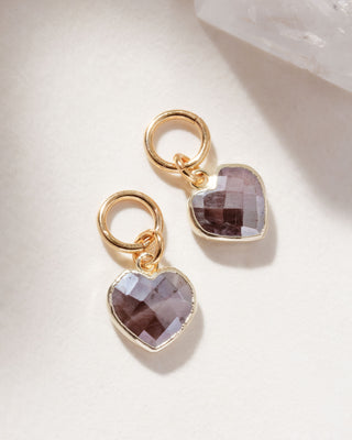 A pair of interchangeable hoop earring charms with heart shaped coffee moonstone gemstone displayed on a white surface.
