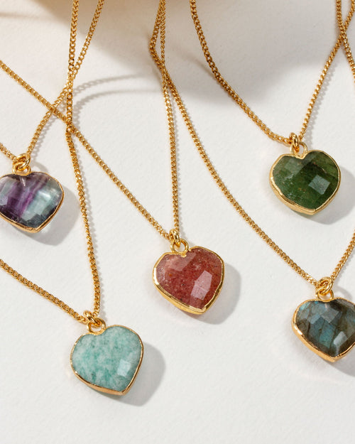 Collection of heart-shaped gemstone gold chain necklaces in various colors