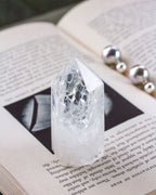 A clear quartz gemstone tower with a crystalline appearance