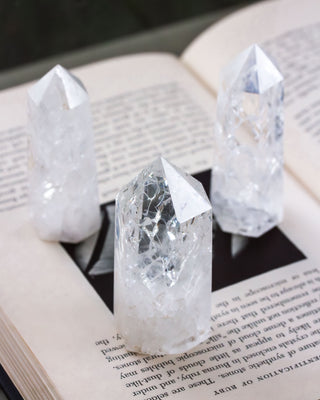 Three Quartz tower obelisks arranged on a book.