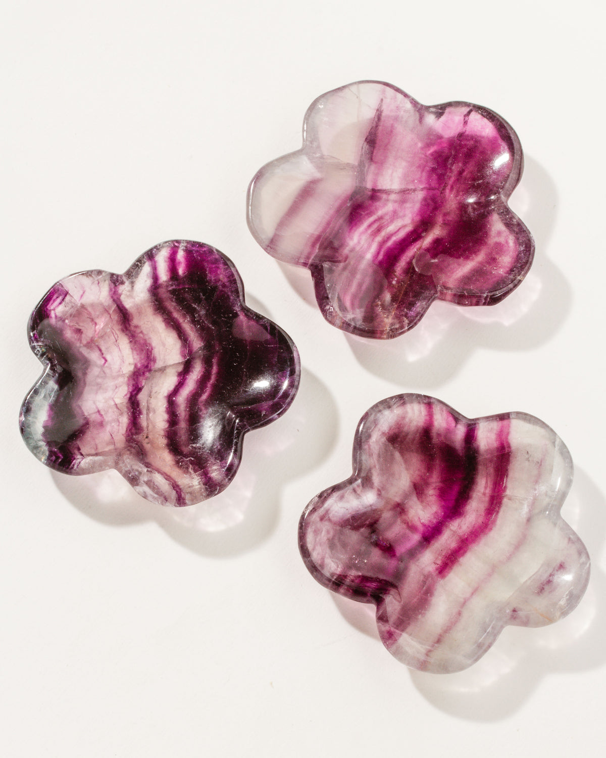 Collection of 3 floral shaped, reddish pink and purple and white fluorite gemstone catchall