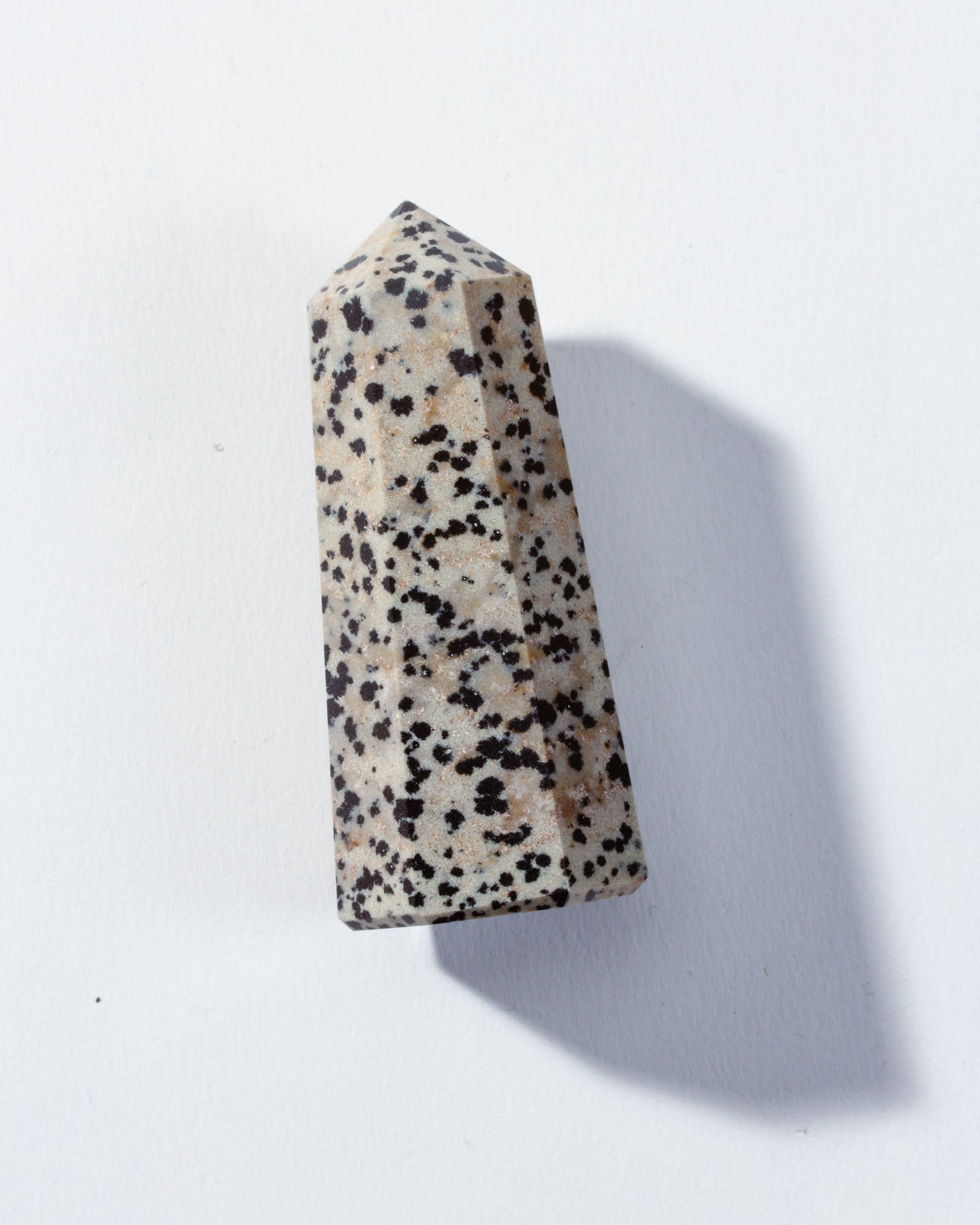 A Dalmatian Jasper crystal tower with a natural speckled pattern
