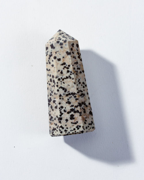 A Dalmatian Jasper crystal tower with a natural speckled pattern