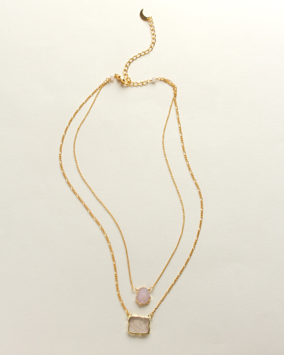 Complete image of layered necklace with a gold chain and pink Druzy and rose quartz pendants