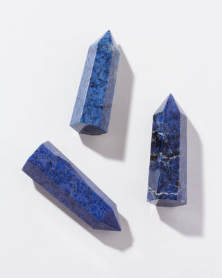 Three Dumortierite gemstone towers on a white background.