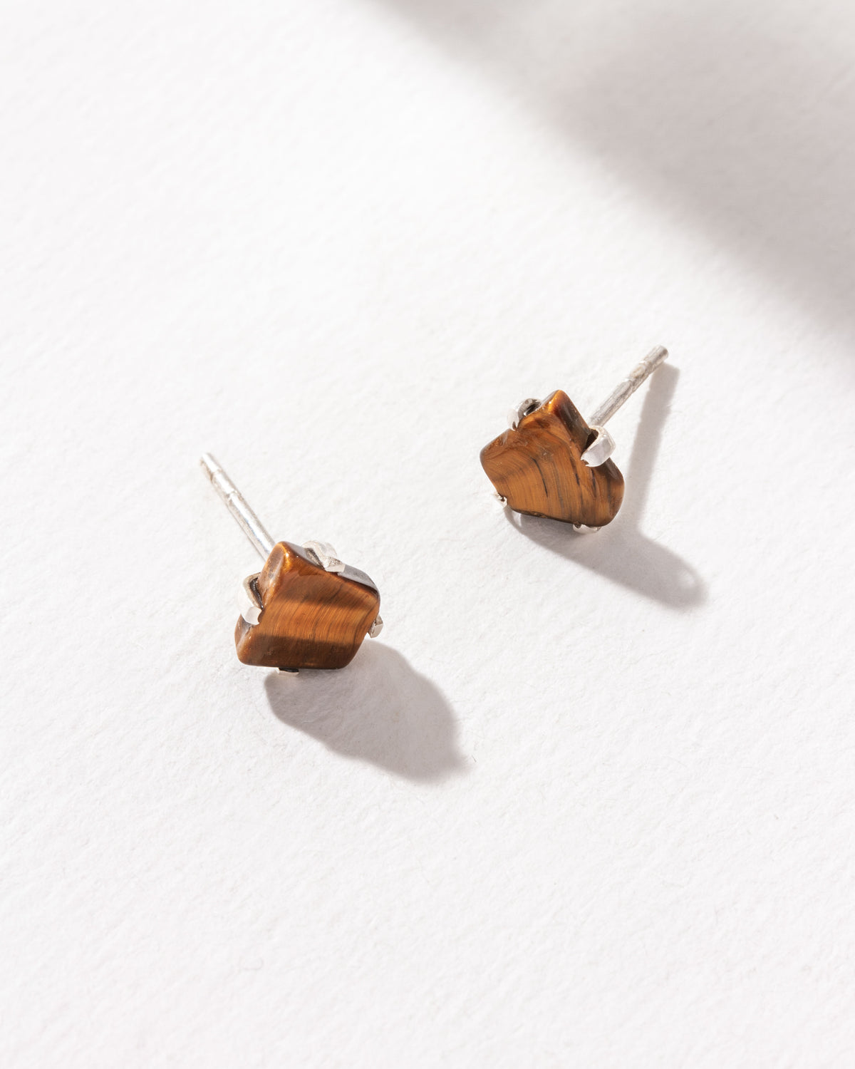 Raw Beauty sterling silver post earrings with a Tigers Eye gemstone.