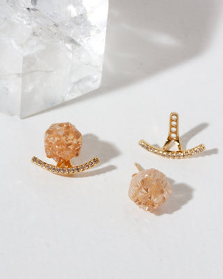 Pair of gold front-back druzy post CZ jacket earrings on a light background