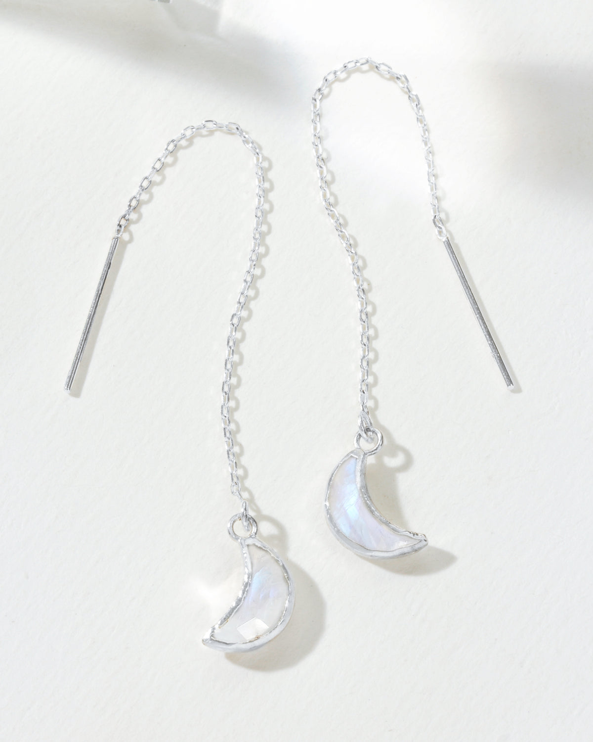 Two sterling silver Eclipse Threader Earrings with moonstone crescent pendants are