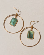 A pair of gold hoop dangle earrings with rectangular green labradorite stone charms.