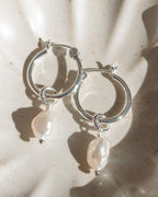 Silver Sea Hoops on a decorative plate, featuring luminous Keshi pearls.