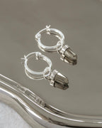 Silver hoop earring with pyrite charms.