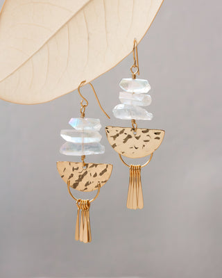 Gold and clear quartz fish hook fringe statement  earrings on a grey background