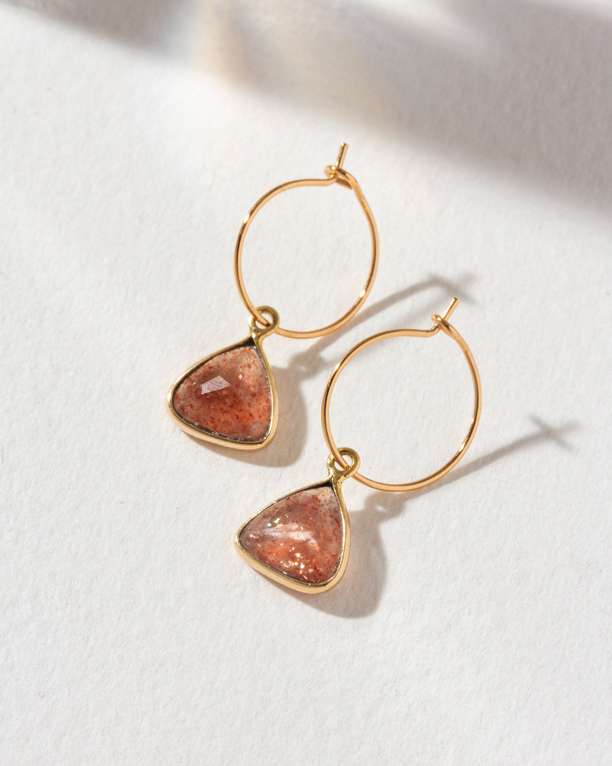 Bermuda Triangle Mini Hoops with a sunstone gemstone and gold hoops.