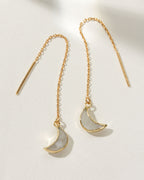 Gold threader earrings with moonstone crescent pendants.