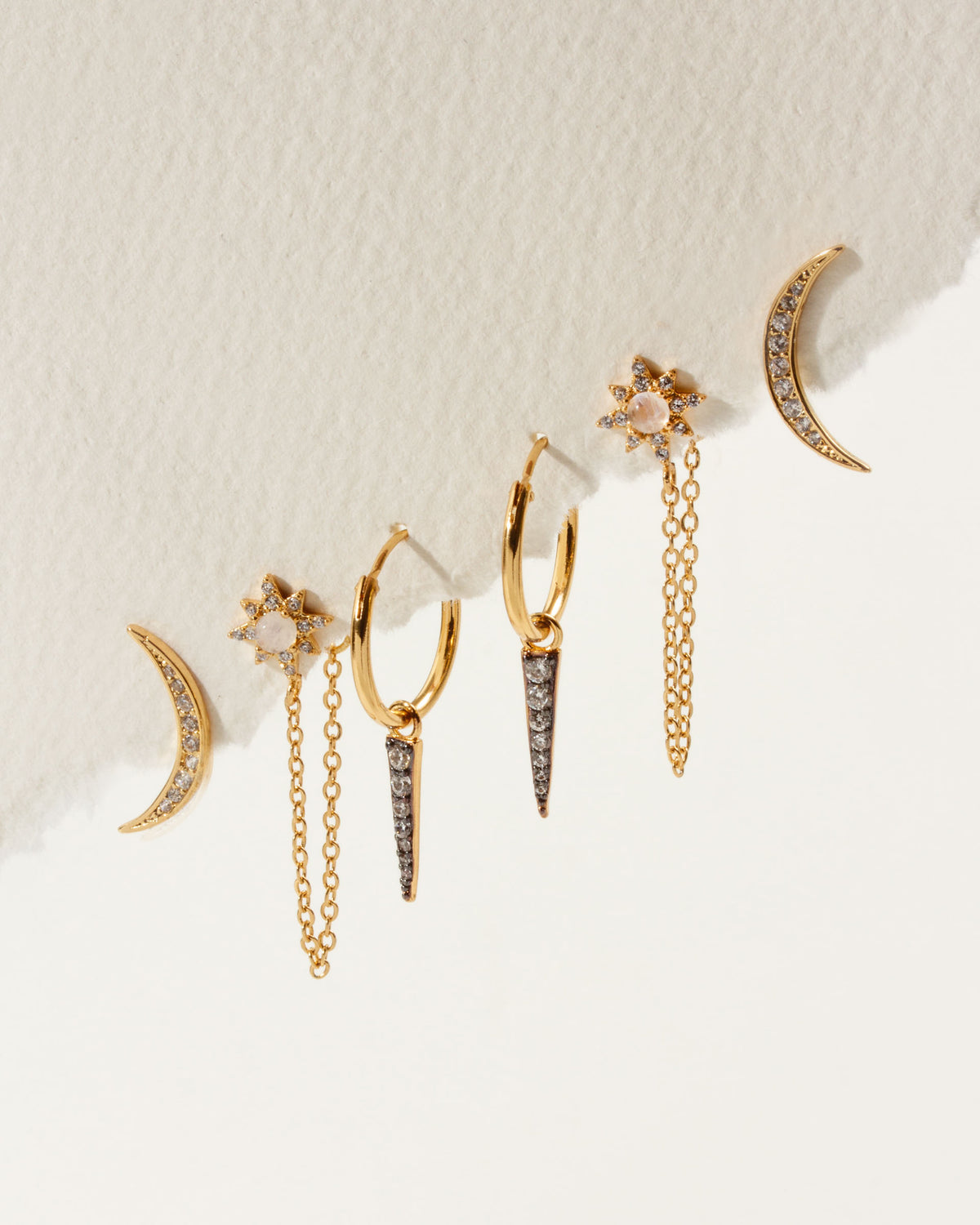 Twilight earring set with gold moon climbers, moonstone star studs, and charm hoops