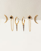 The Twilight Earring Set features moon, spike and onyx starburst gold earrings with clear gemstones.