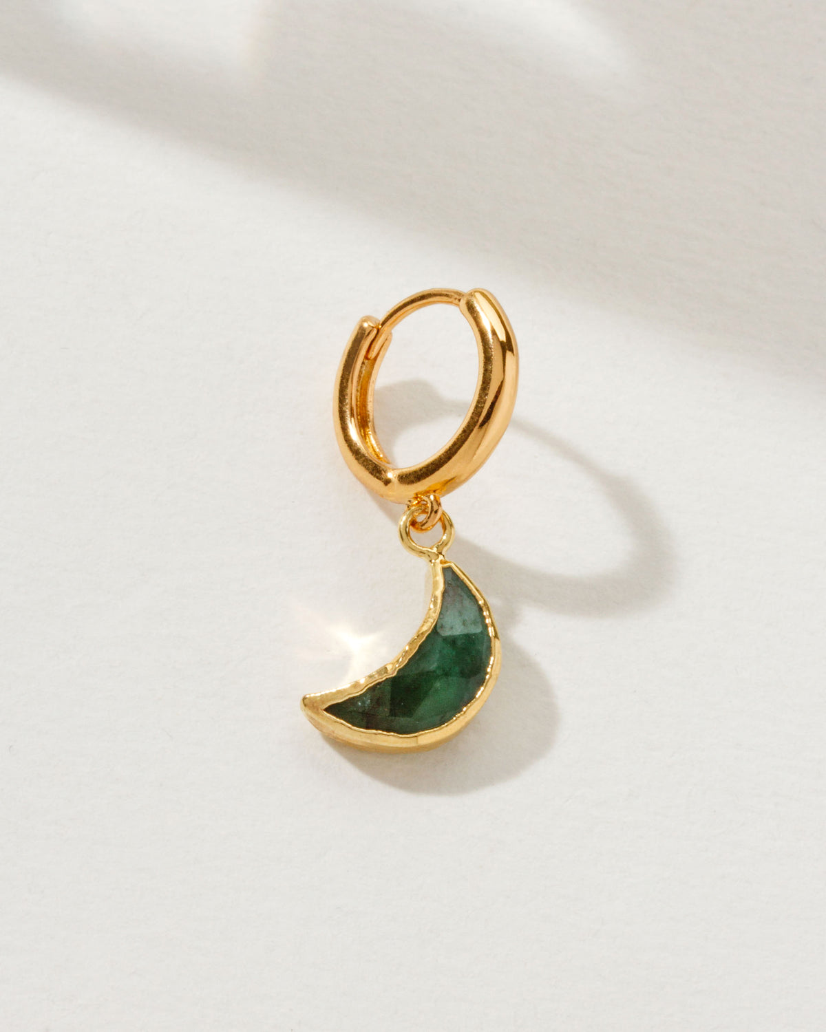Lunar Loop Solo Hoop Earring with an Emerald gemstone and gold hoop.
