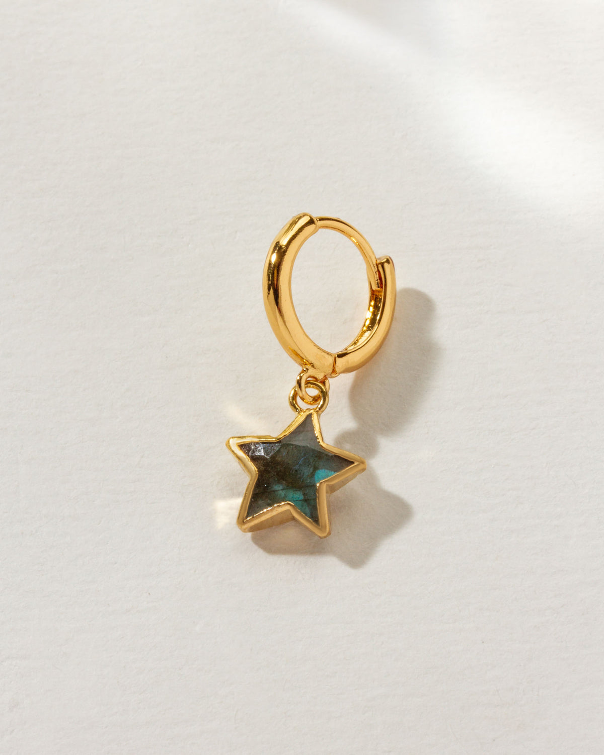 Seastar Solo Hoop Earring with a gold huggie hoop and Labradorite star-shaped gemstone dangle.
