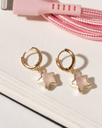 Rose quartz star charm gold huggie hoop earrings.